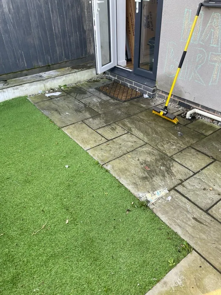 A side patio and path before cleaning