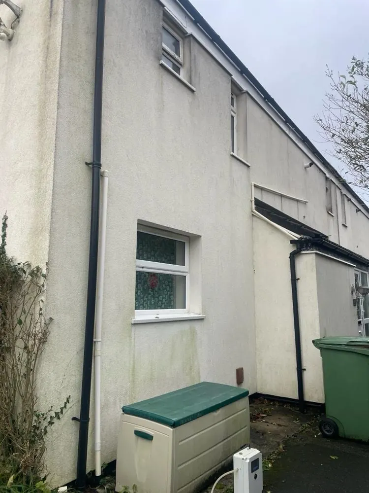 A rendered house wall before cleaning